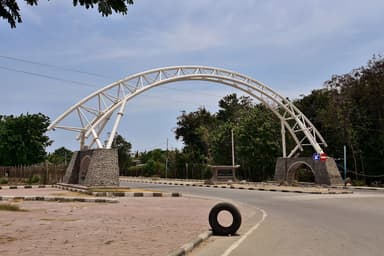 The white arch at the road entrance to Presidente Nicolau Lobato International Airport, Dili