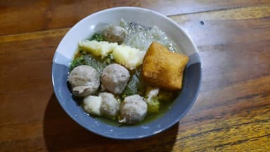 A bowl of bakso: meatballs, noodles and tofu in clear broth