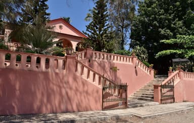 The pink colonial Pousada de Baucau with its stone steps and garden