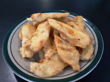 A plate of battered fried banana slices