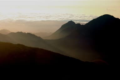 Mountain ridges in silhouette seen from Mount Ramelau at dawn
