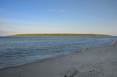Low, flat Jaco Island seen across the channel from Valu Beach